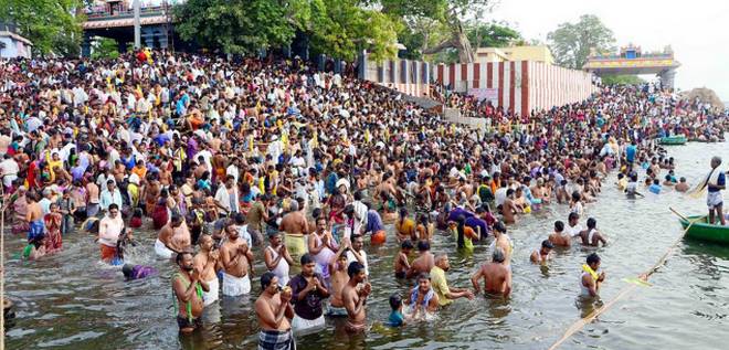 People taking holy dip in the river kaveri