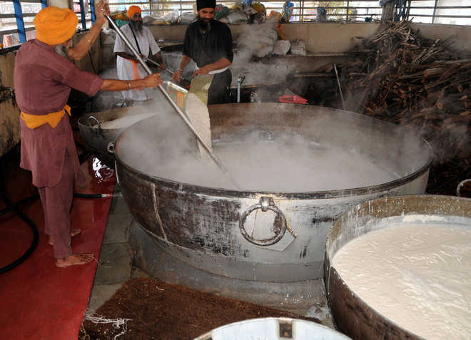 Cook preparing the loving kheer which add to sweet component of Langar