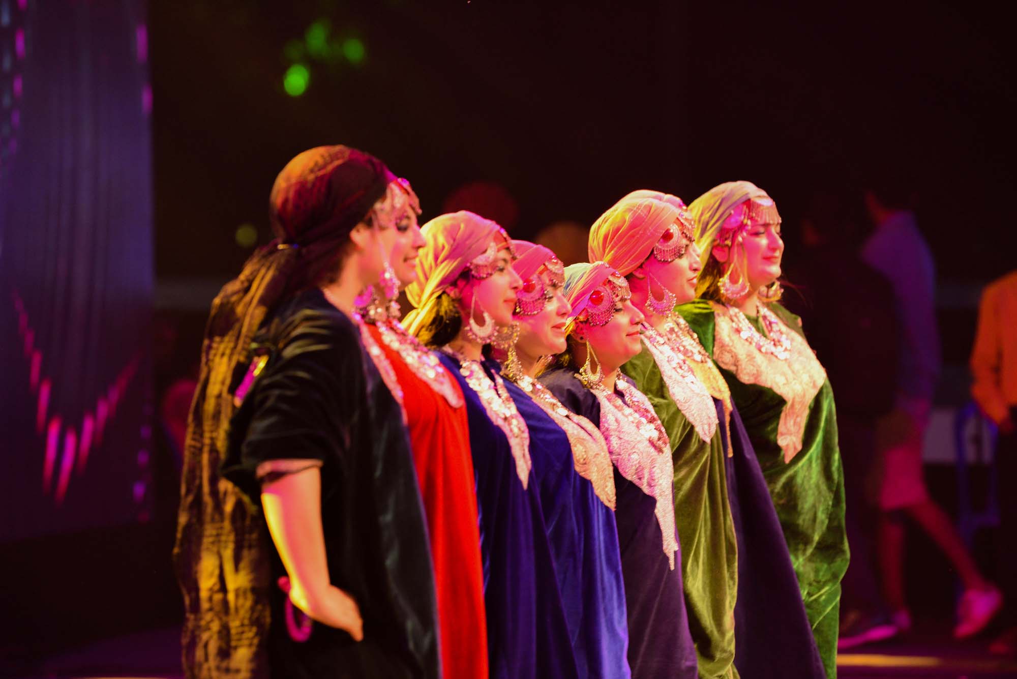 Women wearing colourful outfits performing rouf