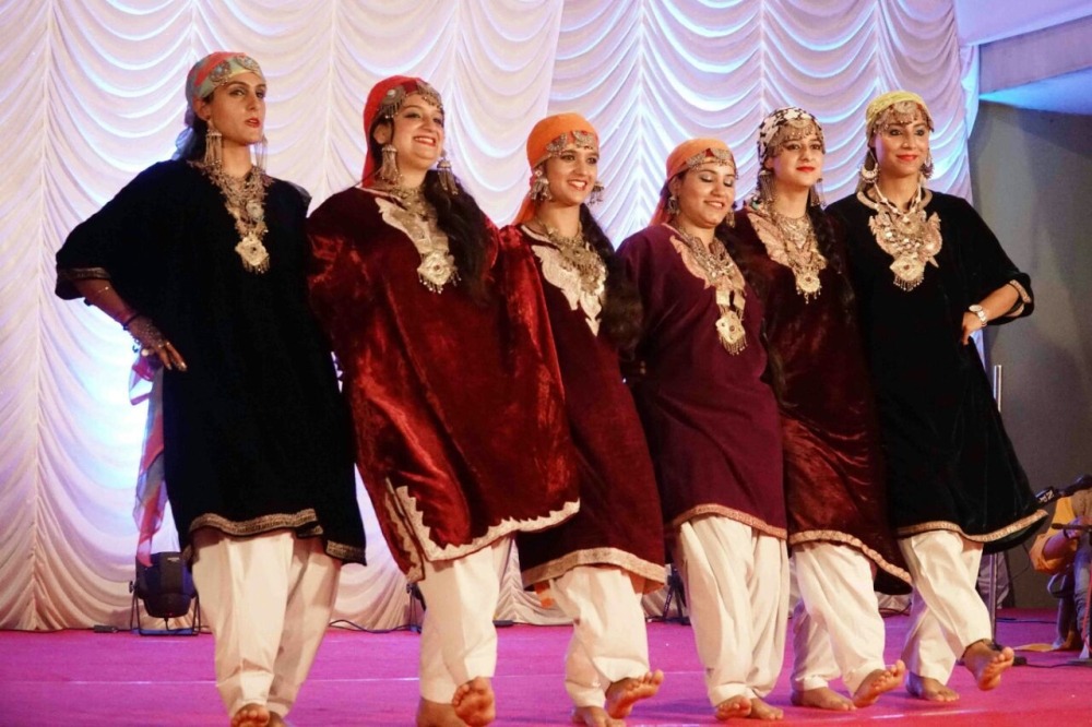 Women wearing maroon performing rouf